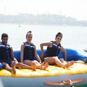 Inflatable Donut Ride Abu Dhabi with friends enjoying sea adventure