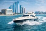 Luxury yacht cruising at high speed in Abu Dhabi waters near city skyline