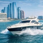 Luxury yacht cruising at high speed in Abu Dhabi waters near city skyline