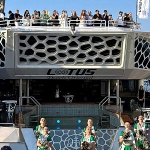 Front view of a luxury hospitality yacht in Abu Dhabi with guests watching Formula 1 events from the upper deck during the day