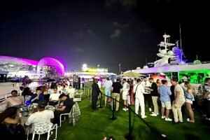 Nighttime yacht hospitality atmosphere in Abu Dhabi during the Formula 1 race with views of Yas Marina