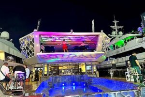 Luxury hospitality yacht in Abu Dhabi with colorful night lighting and a live performance during Formula 1 events at Yas Marina